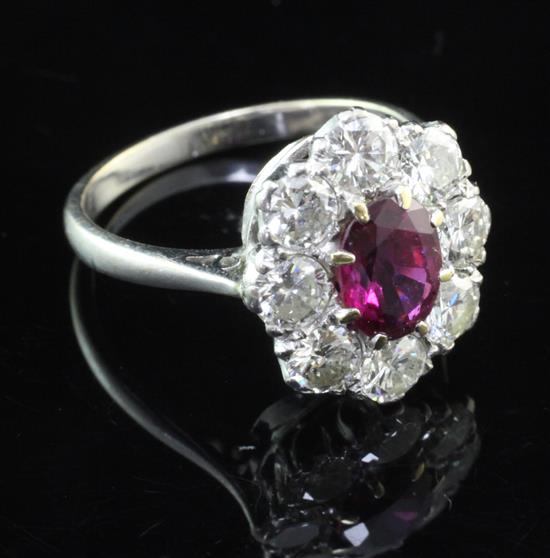 An 18ct white gold, ruby and diamond cluster ring, size N.